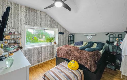a bedroom with a bed and a window at 3 Bedroom Stunning Home In Strömstad in Strömstad