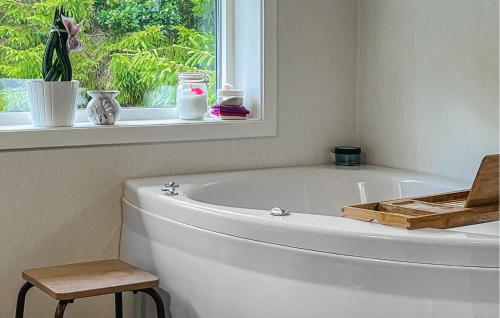 a white bath tub in a bathroom with a window at 3 Bedroom Stunning Home In Strömstad in Strömstad