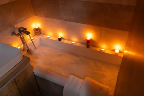 a bathroom with a sink with lights on the wall at Margarétova Apartment in Michalovce