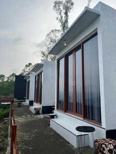 a rendering of a house with large windows at Pinggan tera glamping bali in Gretek