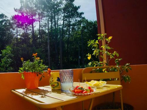 a table with food and plants on a balcony at A Casa Amodiño in O Freixo