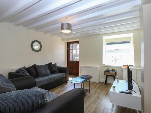 a living room with a couch and a table at 3 York Place in Conwy