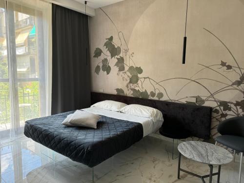 a bedroom with a bed with a plant mural on the wall at Relais Stibbert Florence in Florence