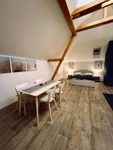 a room with a table and chairs and a bed at Apartmán u Hodináře in Mikulov