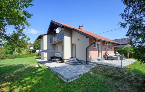 a house with a patio and a yard at 2 Bedroom Cozy Home In Duga Resa in Duga Resa