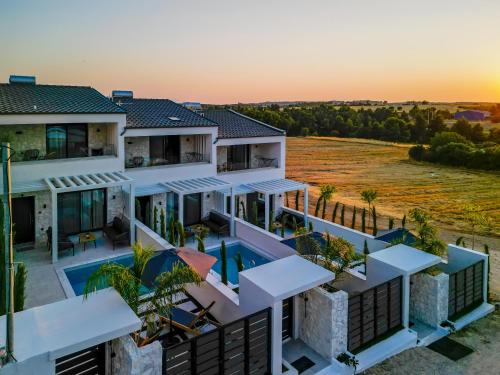 an aerial view of a house with a swimming pool at Bela Villas in Kallithea Halkidikis