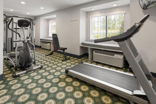 a fitness room with a treadmill and a gym at Microtel Inn by Wyndham - Albany Airport in Latham