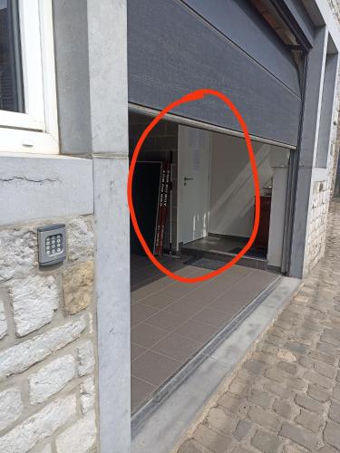 ajar window of a building with a red circle at Le Vieux Sart de Sprimont in Sprimont