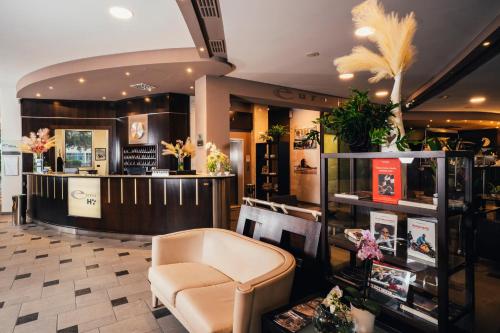 a store with a chair and a counter with flowers at Euro Hotel in Imola