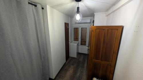 a hallway of a room with a door and a bathroom at Appartement de village in Monacia-dʼAullène