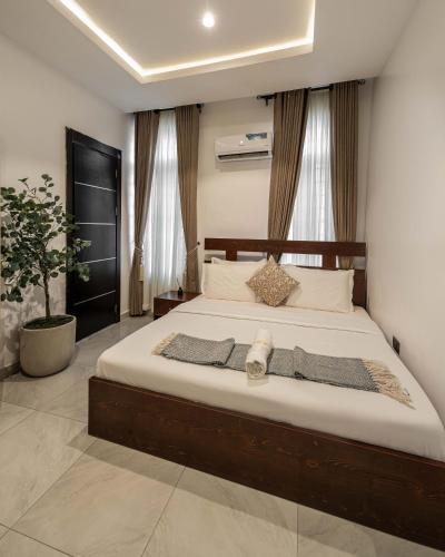 a bedroom with a large bed in a room at Topaz Ologolo, Lekki in Lekki