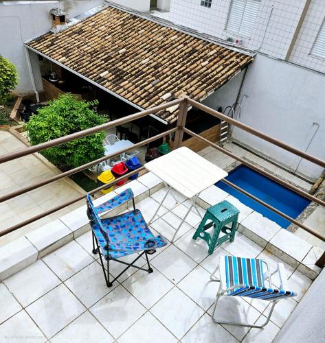 an overhead view of a patio with two chairs and a table at Hostel Castelo in Belo Horizonte