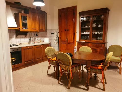 a kitchen with a wooden table and chairs at Camera Emma in Florence