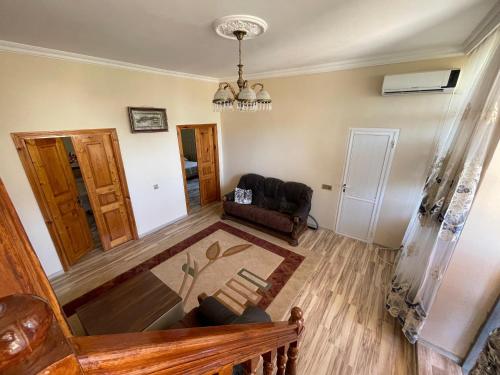 a living room with a couch and a chair at Nabran Suite in Aşağıoba