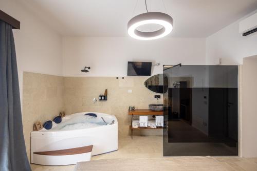 a bathroom with a large tub in a room at Noto Boutique Hotel in Noto