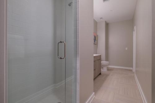 a bathroom with a glass shower with a toilet at Landing at The 600 - Birmingham in Birmingham