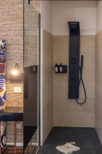 a shower in a bathroom with a black shower head at Noto Boutique Hotel in Noto