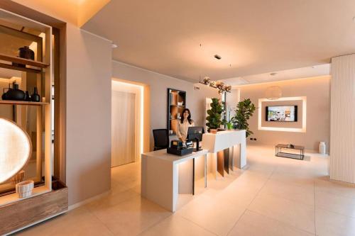 a woman is standing in a hair salon at ananea Tropea Yachting Resort in Tropea