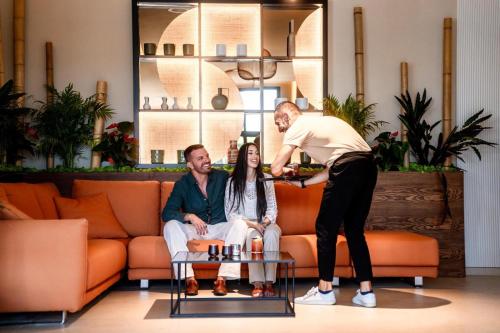 a man standing next to a woman in a living room at ananea Tropea Yachting Resort in Tropea