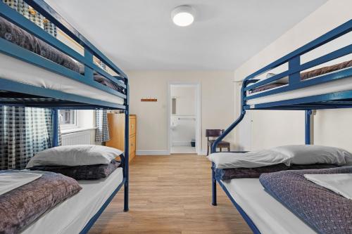 two bunk beds in a room with a hallway at Glendalough International Youth Hostel in Laragh