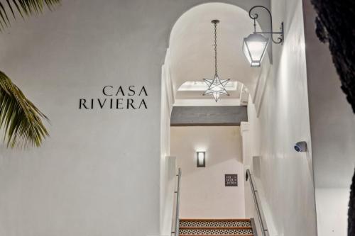 a staircase in a building with a chandelier at Casa Riviera - Boutique Suites in Downtown Santa Barbara in Santa Barbara