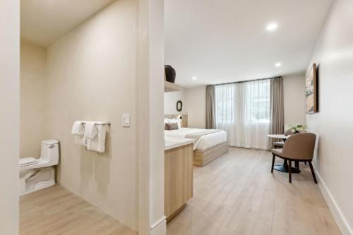 a hotel room with a bed and a desk at Casa Riviera - Boutique Suites in Downtown Santa Barbara in Santa Barbara