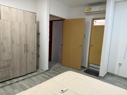 an empty room with wooden doors and a hallway at Apartamentos 53 in Barrancabermeja