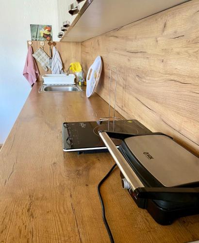 a laptop sitting on top of a wooden table at Philippos in Bujanovac