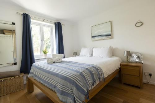 a bedroom with a large bed and a window at Bridge View in Oxford