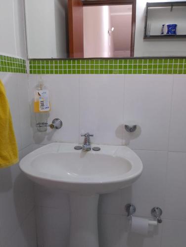 a bathroom with a white sink and a mirror at Tu Estancia en Cali - Valle del Lili in Cali