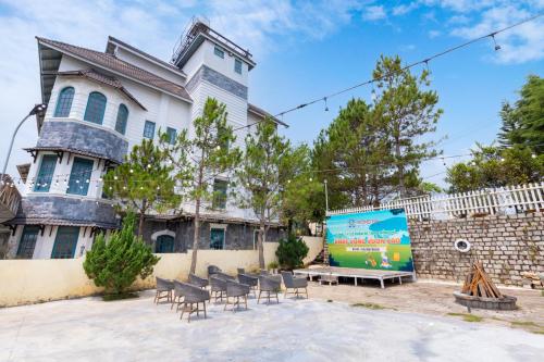 a building with chairs and a table in front of it at Lotus Luxury Villa Da Lat in Da Thien
