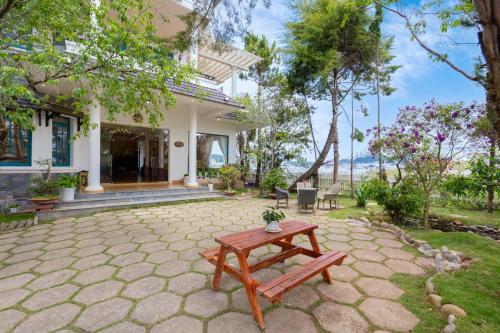 a patio with a table in front of a house at Lotus Luxury Villa Da Lat in Da Thien