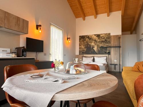 a dining room with a table and a couch at Maso Valèr - Agritur in Tassullo