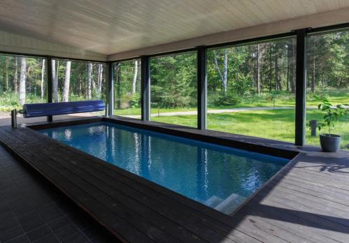 a swimming pool with a bench in a house at Keibulahe Puhkemaja in Keibu