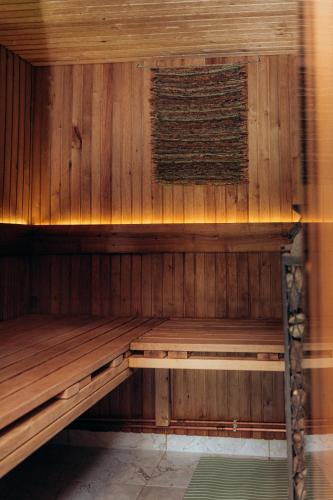 a wooden sauna with a wooden bench in it at Dūjas in Duķuri