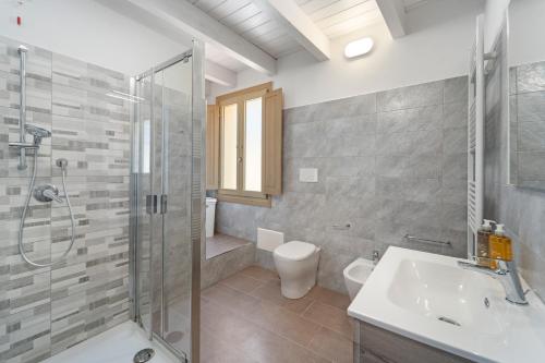 a bathroom with a shower and a sink and a toilet at Casa Vacanze Sa Domixedda in Guspini