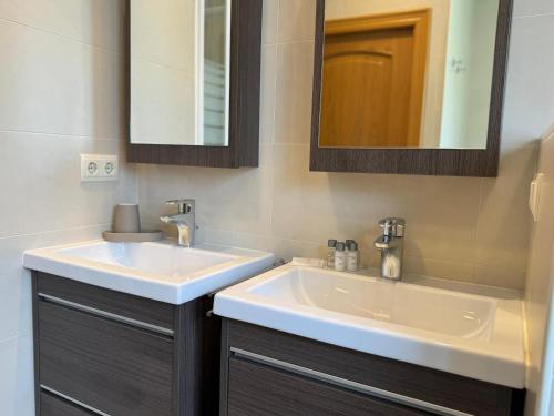 a bathroom with two sinks and a mirror at Casa Marsal - Proap Apartments in Encamp