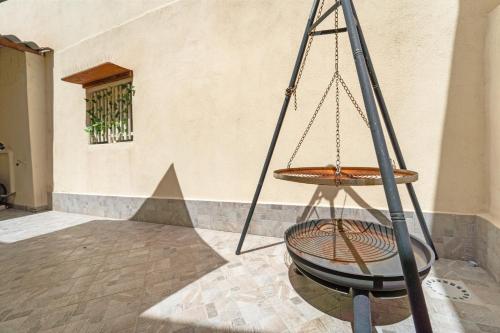 a swing in front of a building at Casa Vacanze Sa Domixedda in Guspini