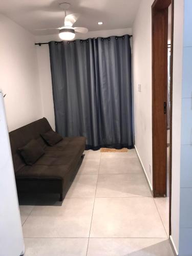 a living room with a brown couch in front of a window at Apartmento com Jacuzzi para DOIS Bingen Petrópolis in Petrópolis