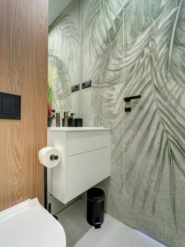 a bathroom with a white sink and a shower at Miral Apartament nad Jeziorem Czorsztyńskim in Kluszkowce