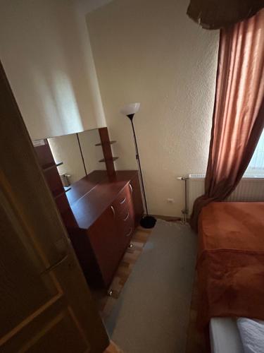 a bedroom with a dresser and a desk with a lamp at Casa Leone Hotel&Restaurant in Popova Shapka