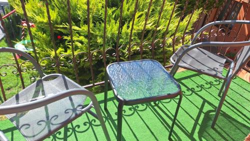 a couple of chairs sitting on top of a fence at Rafa in Trzęsacz