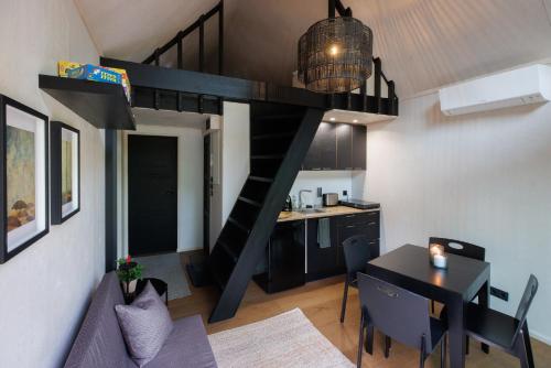 a living room and kitchen with a loft bed at Keibulahe Puhkemaja in Keibu