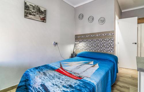 a bedroom with a bed with a painting of a boat at Gorgeous Apartment In Algarrobo With Wifi in Algarrobo