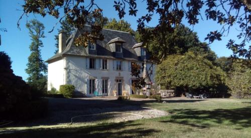 a large white house with a blue roof at Chateau De Chaunac in Naves