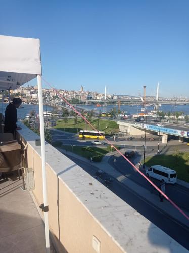 a man sitting on a roof looking out at a highway at Vento in Istanbul