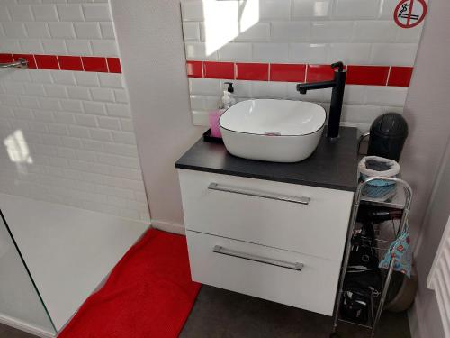 a bathroom with a white sink on a counter at Chez Marie Claude in Le Mans