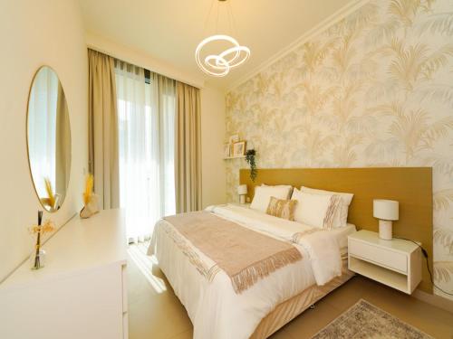 a bedroom with a large bed and a mirror at Luxury Cozy Minimalist 1BR Haven Connected to Dubai Mall in Sabkhah