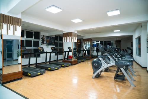 a gym with a bunch of treadms and cardio machines at Capital Hotel and Spa in Addis Ababa