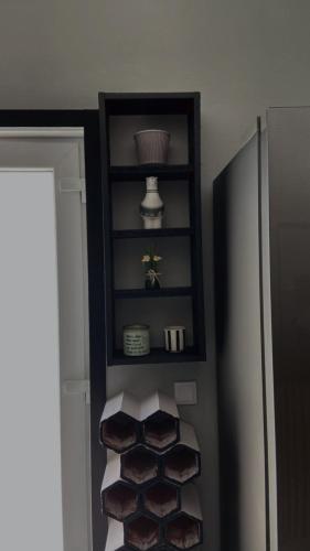 a room with a shelf with towels and a refrigerator at Casa de Ferias Tranquilo in Bitarães